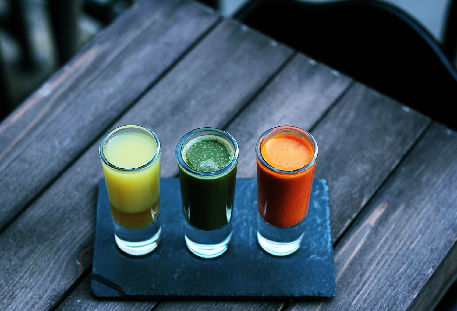 Trzy szklanki ze zdrowymi, owocowo-warzywnymi sokami